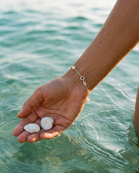Céleste Pearl Bracelet Sterling Silver worn, hand over sea water editorial