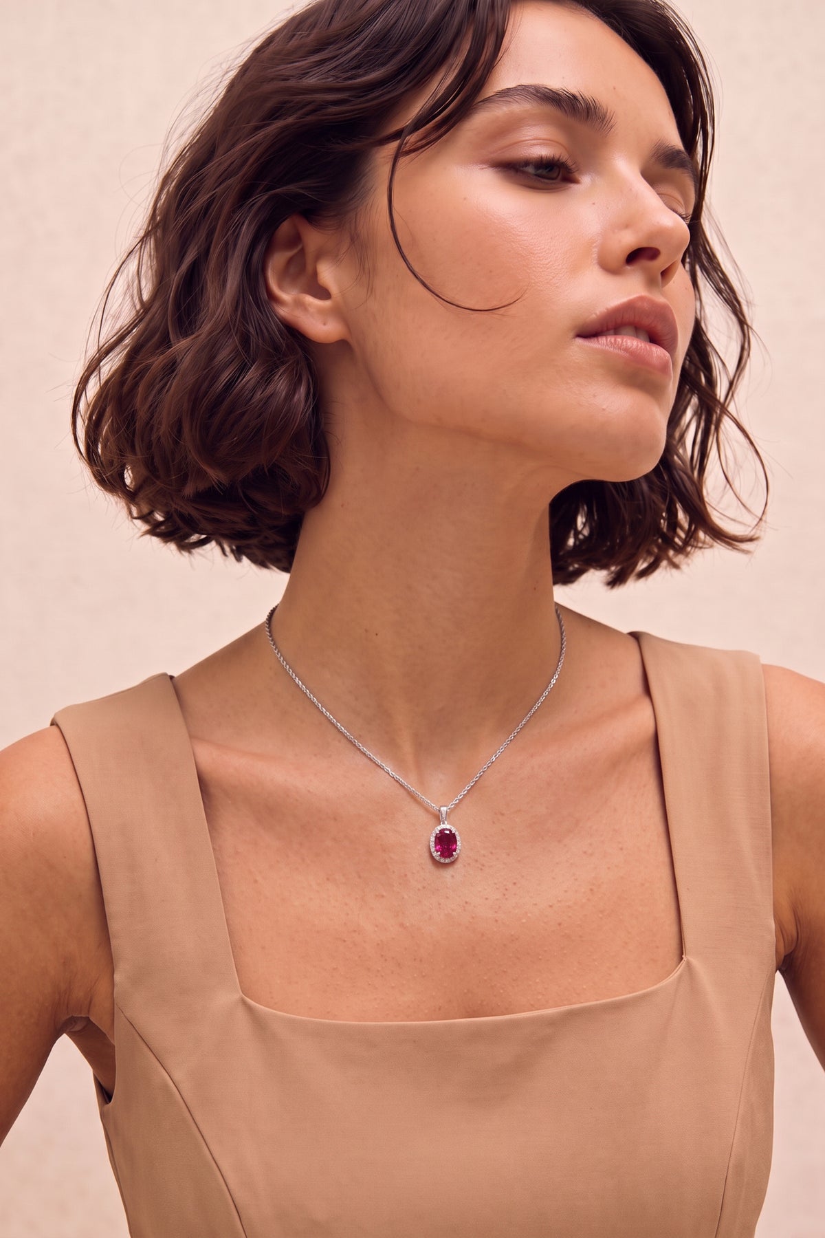 Oval Ruby and Diamond Halo Pendant Necklace on model