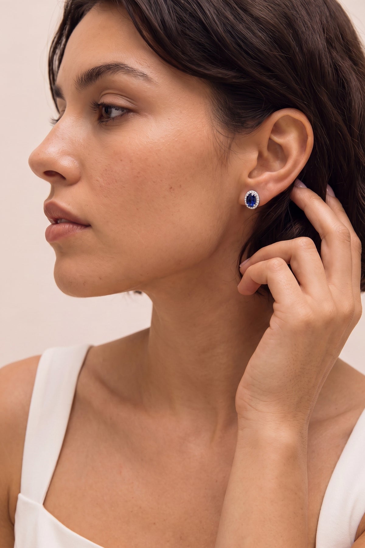 Oval Sapphire and Diamond Halo Stud Earrings on model