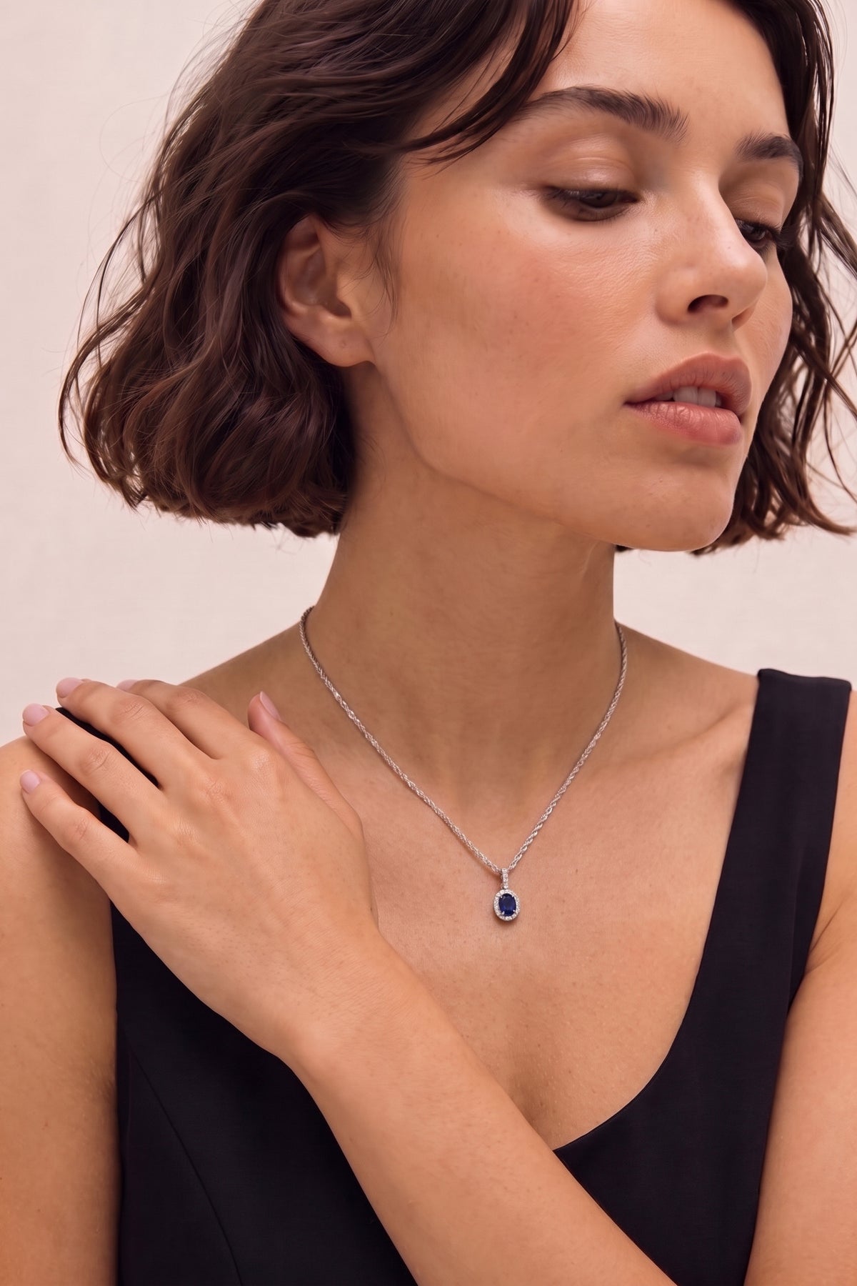 Oval Sapphire and Diamond Halo Pendant Necklace on model